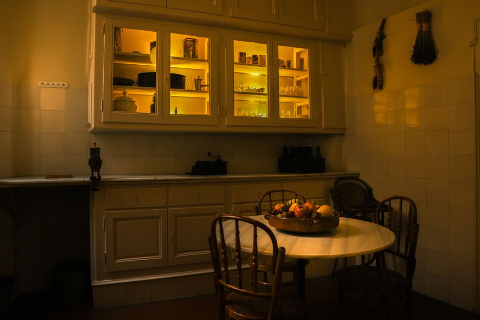 Warm vintage kitchen with illuminated cabinets and dining setup in Barcelona.