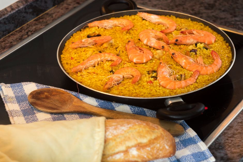 Delicious homemade seafood paella with prawns, cooked on a stovetop, ready to serve.